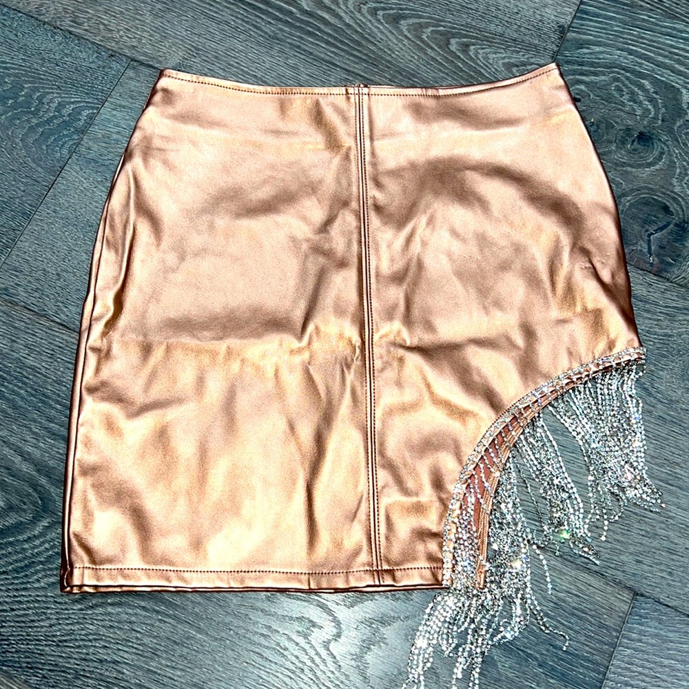 NWT Pleather mini skirt with rhinestone side hem. Size medium junior